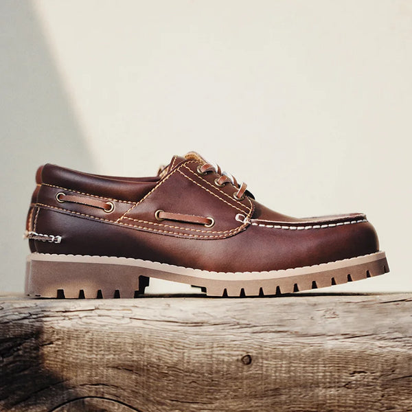 Close-up of red brown derby shoe lace-up detail and leather texture