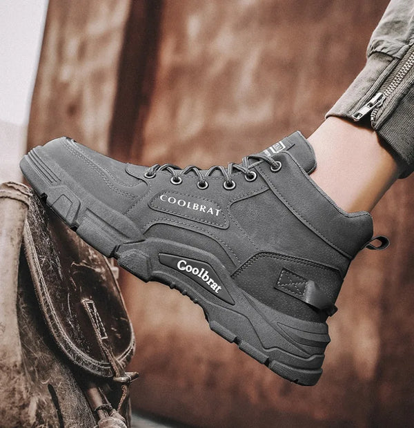 Black suede boots with lace-up design, perfect for men's winter fashion.