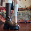 Chic black platform knee-high fashion boots with wedge heel, waterproof design, and subtle bling accents for stylish women.