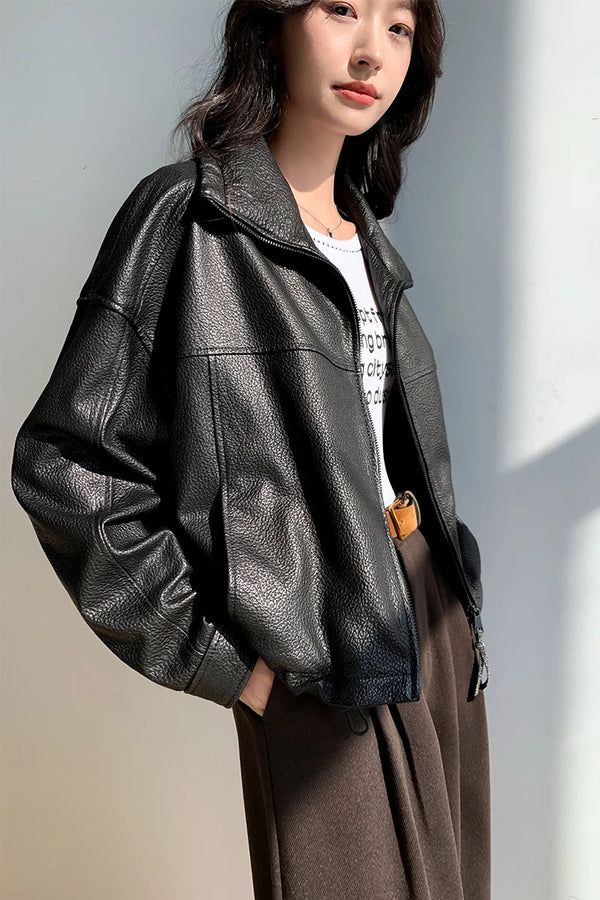 Back view of the cropped leather jacket highlighting its elegant design.