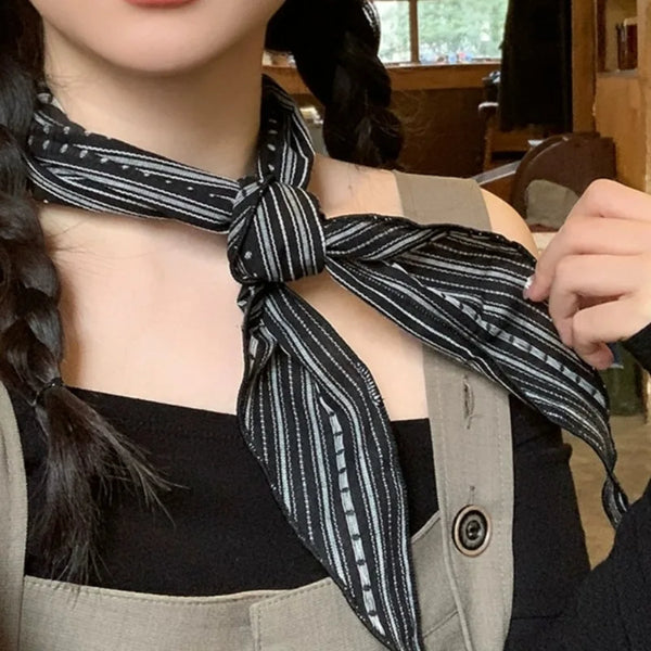 Versatile cotton-linen scarf styled as a neck kerchief.