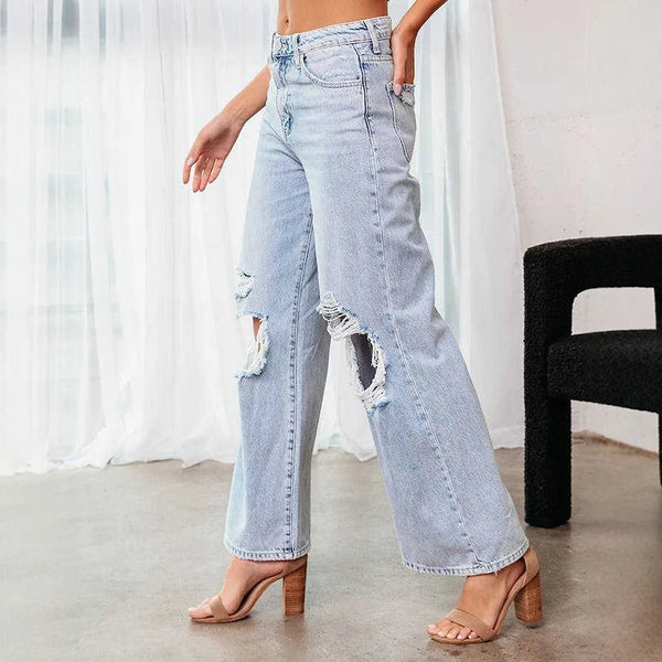 Close-up of ripped details on cool, breathable denim ankle jeans.