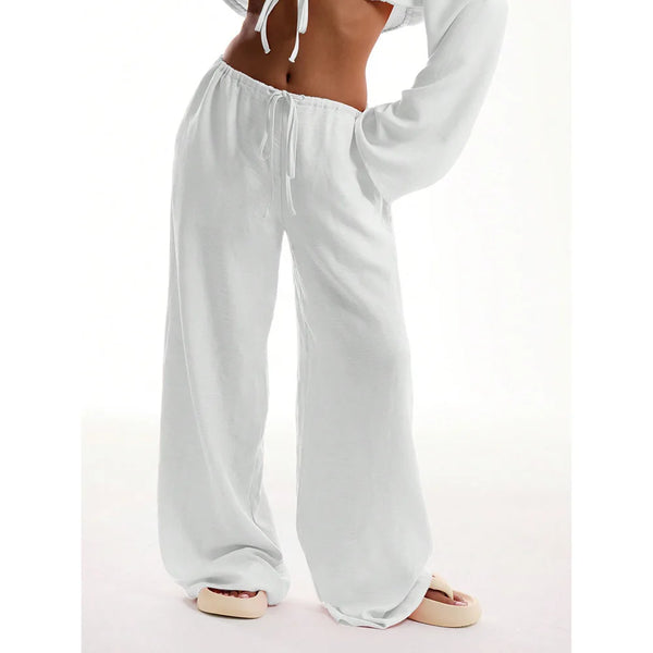 Model wearing wide leg pants in natural light, highlighting flowing fabric and flattering fit