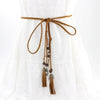 Bohemian braided faux leather skinny belt for women in camel, perfect for casual and formal outfits with fringe accents.