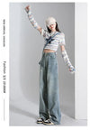 High-waist denim jeans styled with a trendy crop top for a retro vibe.