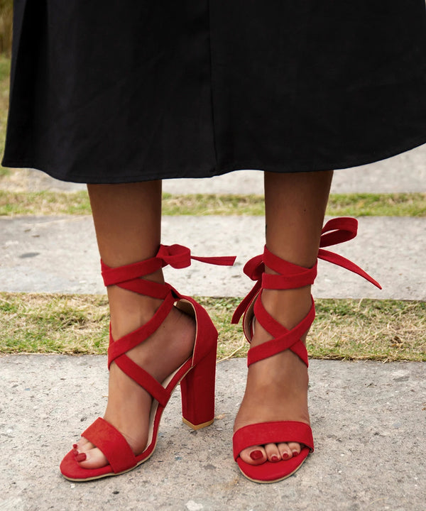 Trendy fuchsia stiletto sandals featuring a secure zipper closure.