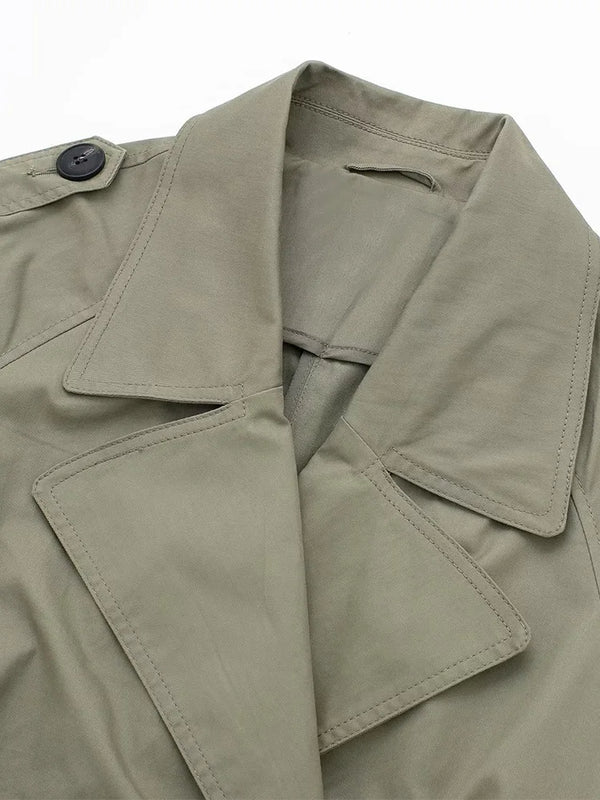 Double-breasted trench coat back view showing x-long length and belt tie