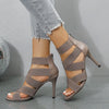 Fashionable white stiletto heels featuring a secure zipper closure.