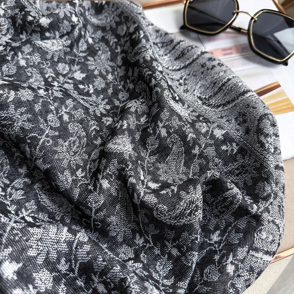 Elegant pashmina shawl folded neatly, highlighting its vibrant colors.