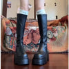 Chic black platform knee-high fashion boots with wedge heel, waterproof design, and bling accents for stylish women.