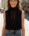 Versatile sleeveless black top featuring vertical pleats and ribbon trim