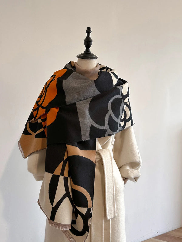 Versatile cashmere-blend shawl worn as a stylish wrap.