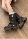 Chic women's mid-calf biker boots with buckle detail, cozy plush lining, and durable rubber sole for stylish winter wear.