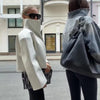 Women's fall jacket in black PU leather with flattering loose silhouette