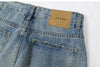 Trendy washed and ripped wide-leg women's jeans with distressed ink-splashed finish for a chic casual look.