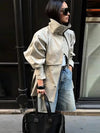 Modern khaki trench coat with turtleneck-inspired collar and structured silhouette
