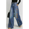 Wide leg denim jeans featuring high waist fit and contemporary metal grommet accents