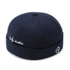 Black docker cap styled on model showing front view
