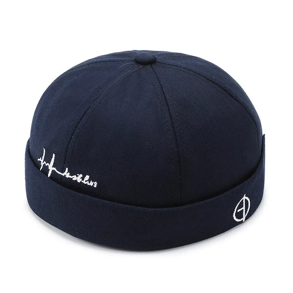 Black docker cap styled on model showing front view