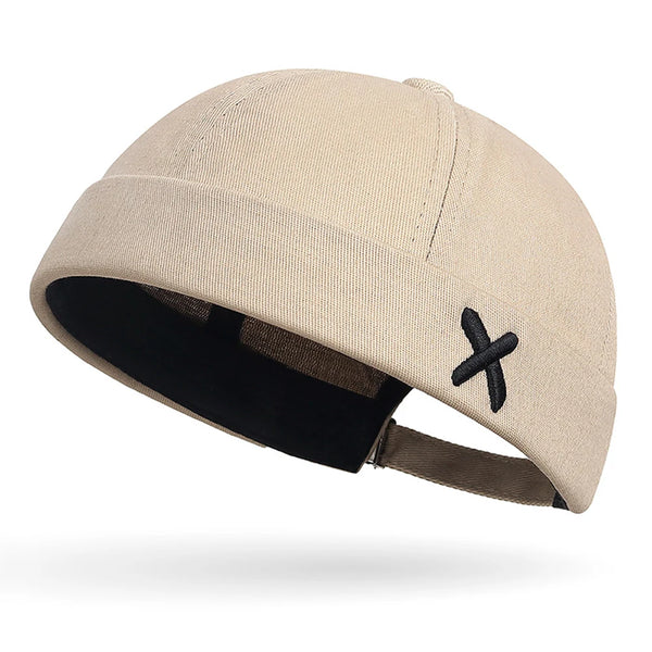 Adjustable docker cap flat lay showing embroidered detail and shape