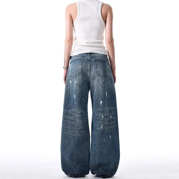 Trendy washed and ripped wide-leg women's jeans with distressed ink-splashed finish for a chic casual look.