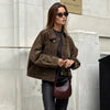 Front view of black faux leather bomber jacket with smooth zipper and athletic silhouette