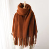 Luxurious scarf in muted coral, featuring a generous length.