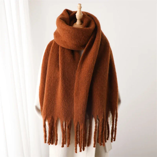 Luxurious scarf in muted coral, featuring a generous length.