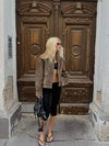 Chic women's leather jacket with button closure, lapel collar, and short length, perfect for autumn fashion and urban style.