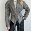 Chic belted leather bomber jacket for women, featuring lace-up detail, notched lapel, and hood for stylish autumn wear.