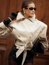 Woman wearing elegant double-breasted trench coat with waist-defining belt