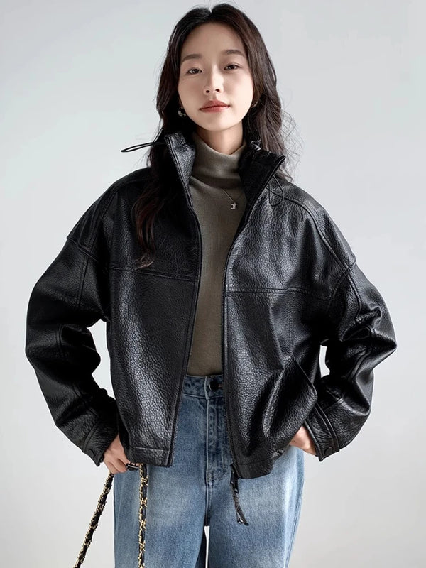 Model showcasing the cropped fit of the chic vintage leather jacket.