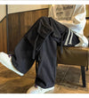 Men's urban clothing: wide-leg hip-hop jeans with drawstring.