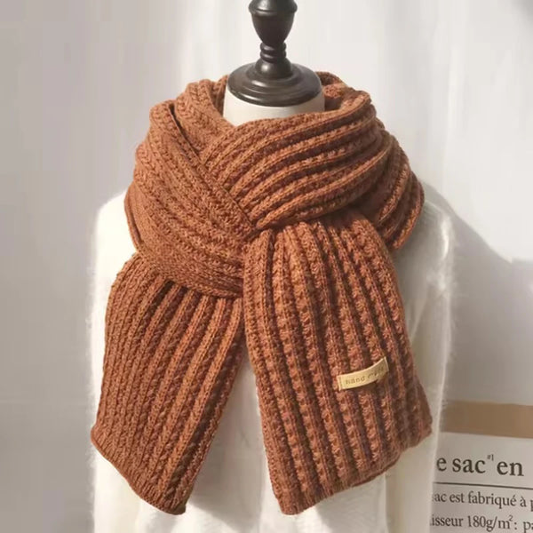Versatile chunky knit scarf styled with a winter hat and gloves.