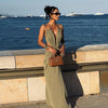 Backless evening gown with halter neckline and contemporary waist cutout styling