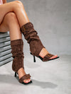 Statement stiletto boots blending casual denim with elegant suede accents