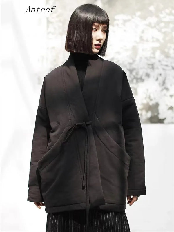 Oversized beige cotton padded jacket with belt and deep pockets displayed on white background
