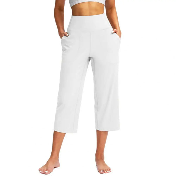 Chic high-waist wide-leg capri yoga pants with pockets, perfect for activewear and casual outings in nylon-spandex blend.