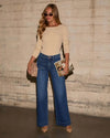 Chic high-waisted wide-leg jeans for women with pockets, distressed details, and a relaxed fit for stylish comfort.