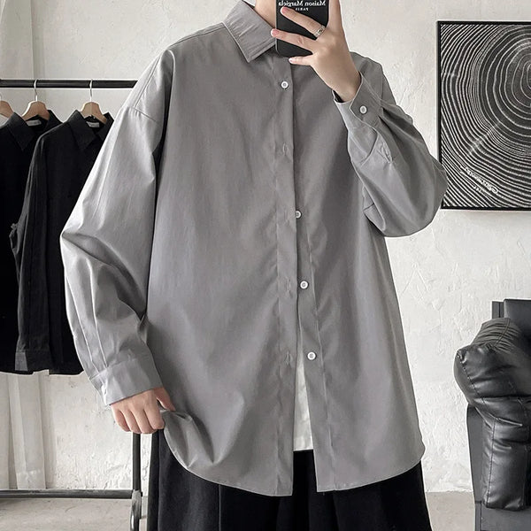 Oversized long sleeve casual shirt for men and women, featuring a Mandarin collar and single-breasted closure in solid color.