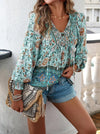 Bohemian lace-up V-neck blouse for women with vibrant print, lantern sleeves, and loose fit, perfect for spring and summer.