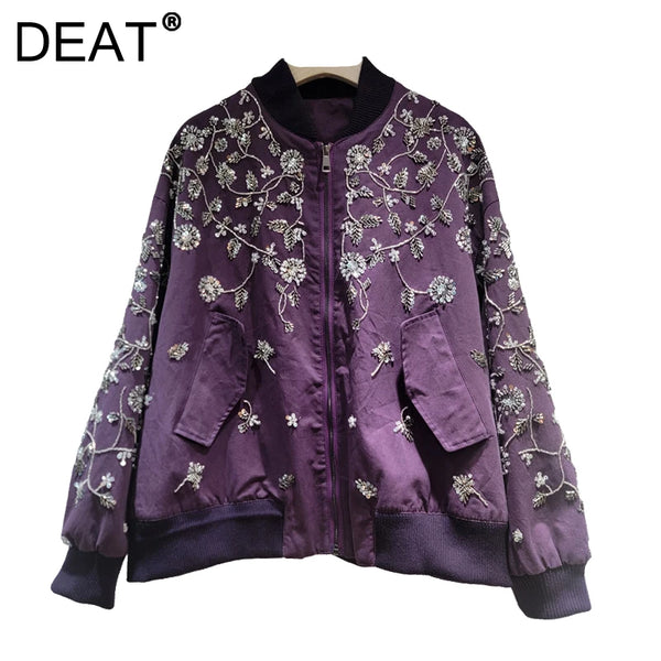 Close-up of hand-applied sequin embellishments and embroidered details on jacket fabric