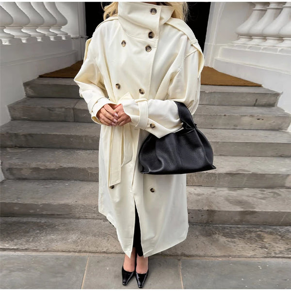 Long cream colored trench coat showing elegant drape and timeless styling