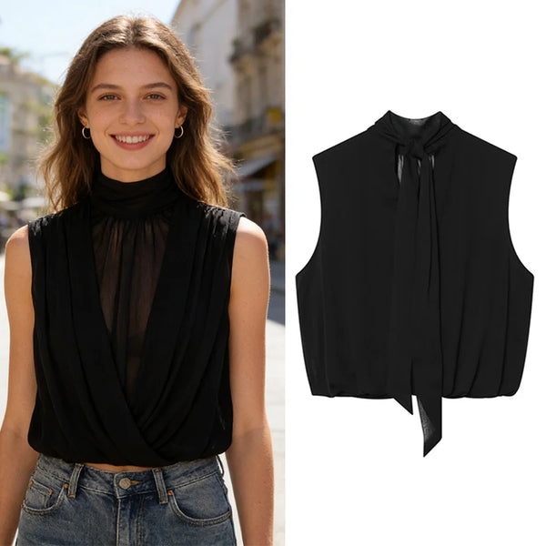 Sleeveless pleated black top with ribbon detail on white background