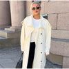 Elegant cream colored trench coat showing versatile layering piece design