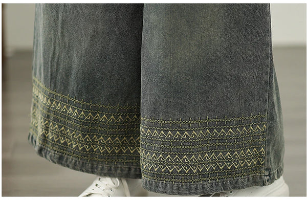 Vintage embroidered wide-leg jeans for women in light wash, featuring elastic waist and ethnic-inspired designs. Perfect for