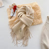 Chic women's scarf in soft gray, ideal for layering and staying warm this winter.