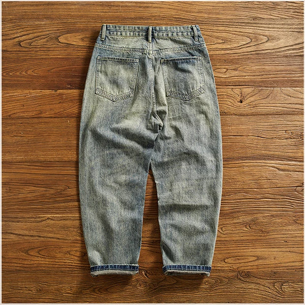 Flat lay of Rebel Spirit Distressed Jeans with outdoor gear, perfect for adventure wear.