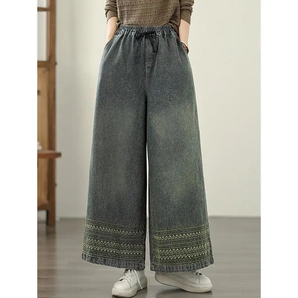 Vintage embroidered wide-leg jeans for women, featuring elastic waist, ethnic design, and light wash for autumn fashion.