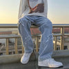 Black wide-leg denim jeans for men, featuring a relaxed fit and hip hop style.